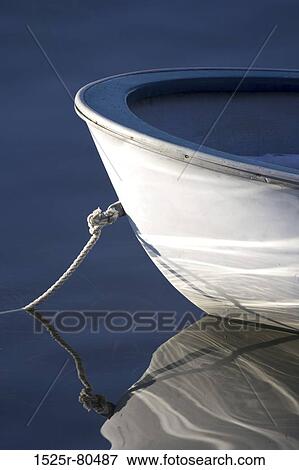 Stock Photo - Reflection of a moored boat in water. Fotosearch
