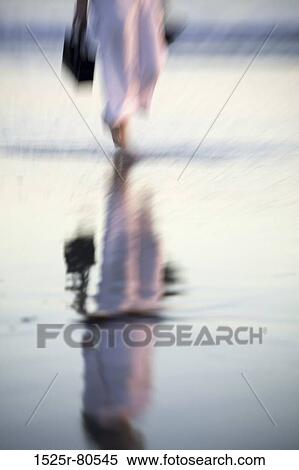 Reflection of a person wading in water View Large Photo Image Stock Photography - Reflection of a person wading in water. Fotosearch