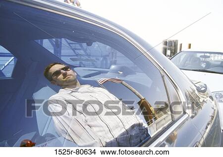 Reflection of a young man on a car window View Large Photo Image Picture - Reflection of a young man on a car window. Fotosearch