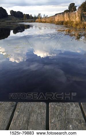 Reflection of clouds in water View Large Photo Image Stock Image - Reflection of clouds in water. Fotosearch