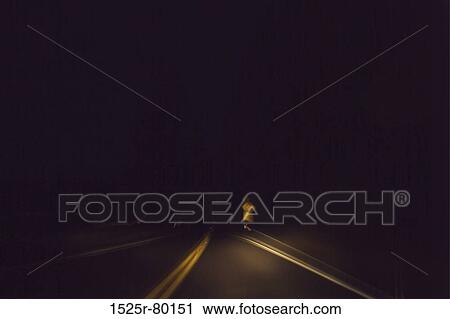 Stock Image - Road sign on the roadside at night. Fotosearch