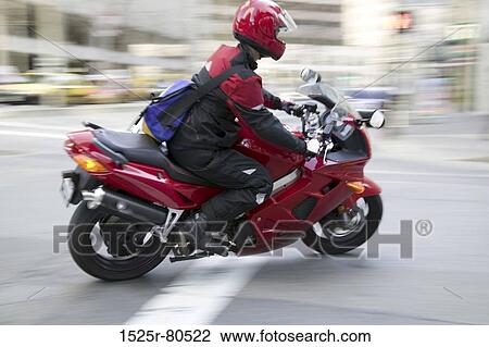 Side profile of a man riding a motorcycle View Large Photo Image Stock Image - Side profile of a man riding a motorcycle. Fotosearch