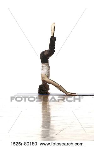 Side profile of a woman doing headstand View Large Photo Image Stock Image - Side profile of a woman doing headstand. Fotosearch