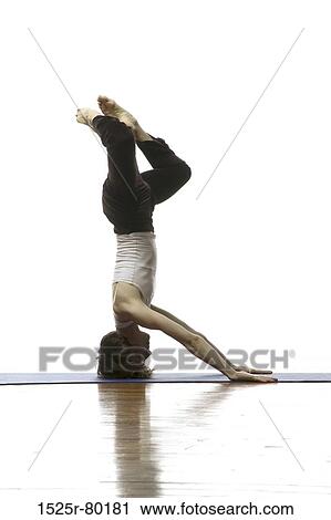 Side profile of a woman doing headstand View Large Photo Image Stock Image - Side profile of a woman doing headstand. Fotosearch