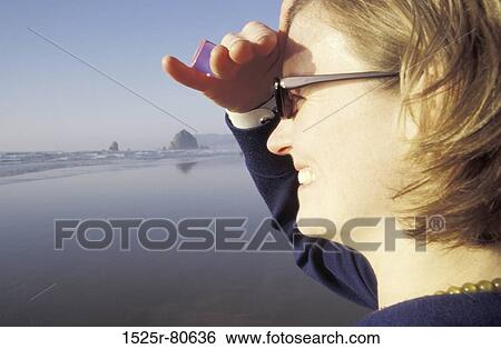 Side profile of a young woman smiling View Large Photo Image Stock Photograph - Side profile of a young woman smiling. Fotosearch