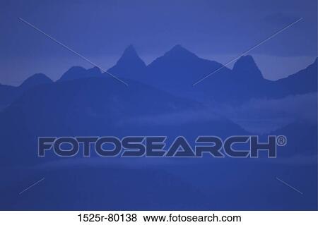 Stock Photo - Silhouette of a mountain range at dusk. Fotosearch