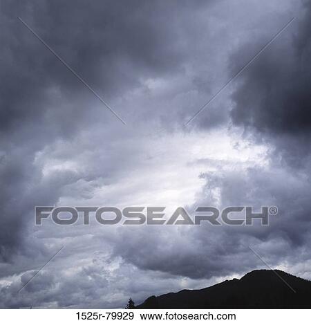 Stock Photo - Storm clouds over a mountain. Fotosearch