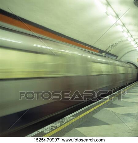 Subway train passing through a subway station View Large Photo Image Stock Photo - Subway train passing through a subway station. Fotosearch