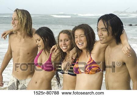 Three young women with two young men standing on the beach View Large Photo Image Stock Photo - Three young women with two young men standing on the beach. Fotosearch