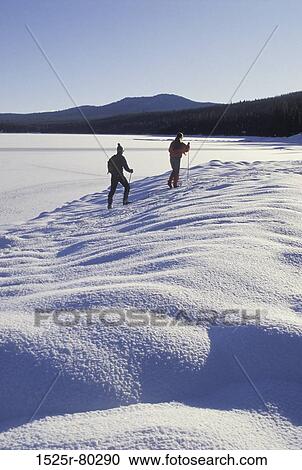 Two hikers on a snow covered landscape View Large Photo Image Stock Image - Two hikers on a snow covered landscape. Fotosearch