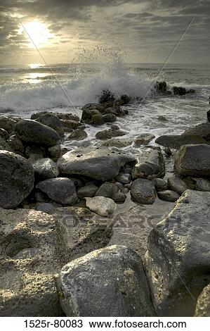 Stock Image - Waves breaking on rocks. Fotosearch