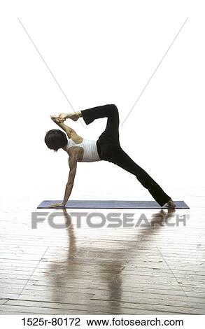 Woman exercising on a mat View Large Photo Image Stock Image - Woman exercising on a mat. Fotosearch