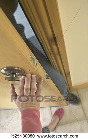 Woman pushing the door trying to stop a man from breaking in View Large Photo Image Stock Image - Woman pushing the door trying to stop a man from breaking in. Fotosearch