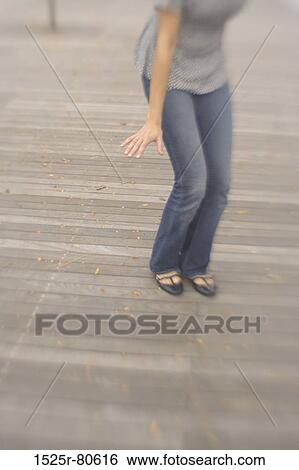 Woman standing on a floorboard View Large Photo Image Stock Photograph - Woman standing on a floorboard. Fotosearch
