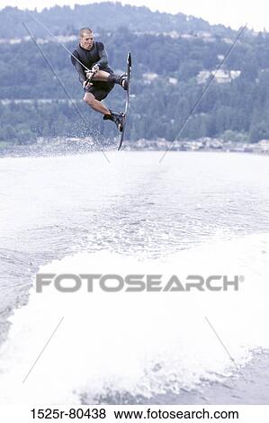 Young man kiteboarding in the sea View Large Photo Image Stock Photo - Young man kiteboarding in the sea. Fotosearch