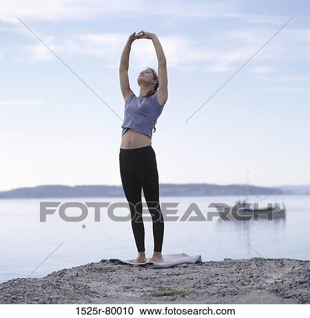 Young woman exercising on the beach View Large Photo Image Stock Image - Young woman exercising on the beach. Fotosearch