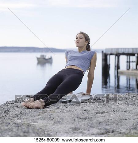Young woman exercising on the beach View Large Photo Image Stock Photo - Young woman exercising on the beach. Fotosearch