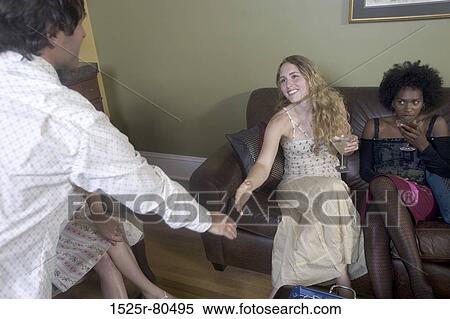 Young woman reaching out for a handshake with a young man View Large Photo Image Stock Photography - Young woman reaching out for a handshake with a young man. Fotosearch