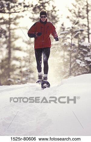 Young woman snowshoeing View Large Photo Image Stock Photograph - Young woman snowshoeing. Fotosearch