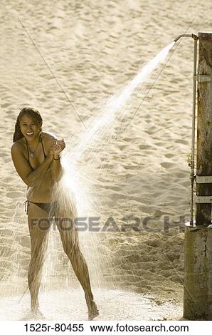 Young woman taking a shower on the beach View Large Photo Image Stock Photography - Young woman taking a shower on the beach. Fotosearch