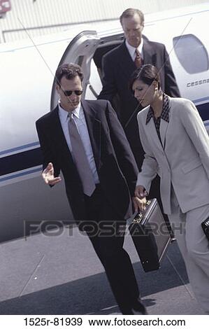 Stock Photo - Business executives exiting an airplane. Fotosearch