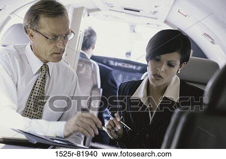 Businessman and a businesswoman talking to each other View Large Photo Image Stock Image - Businessman and a businesswoman talking to each other. Fotosearch