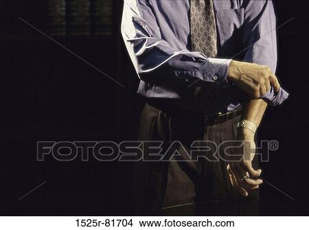 Picture - Businessman folding up his sleeves. Fotosearch
