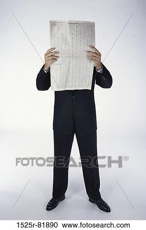 Businessman reading a newspaper View Large Photo Image Stock Image - Businessman reading a newspaper. Fotosearch