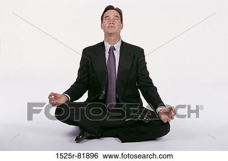 Businessman sitting on the floor meditating View Large Photo Image Stock Photograph - Businessman sitting on the floor meditating. Fotosearch