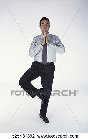 Businessman standing on one leg View Large Photo Image Stock Image - Businessman standing on one leg. Fotosearch
