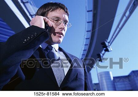 Businessman talking on a mobile phone View Large Photo Image Picture - Businessman talking on a mobile phone. Fotosearch