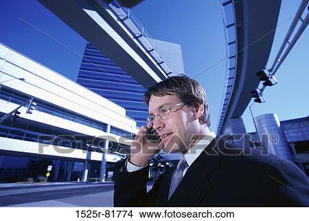Businessman talking on a mobile phone View Large Photo Image Picture - Businessman talking on a mobile phone. Fotosearch