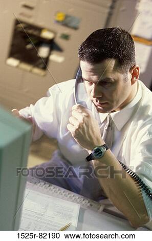 Stock Image - Businessman talking on a telephone. Fotosearch