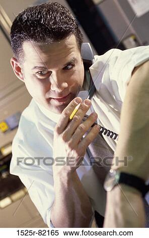 Businessman talking on a telephone View Large Photo Image Stock Photography - Businessman talking on a telephone. Fotosearch