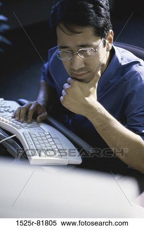 Businessman working on a computer View Large Photo Image Stock Photography - Businessman working on a computer. Fotosearch