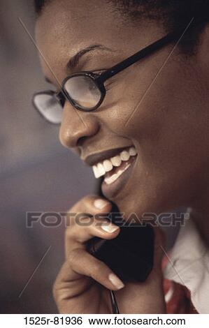 Businesswoman talking on a telephone View Large Photo Image Stock Photograph - Businesswoman talking on a telephone. Fotosearch