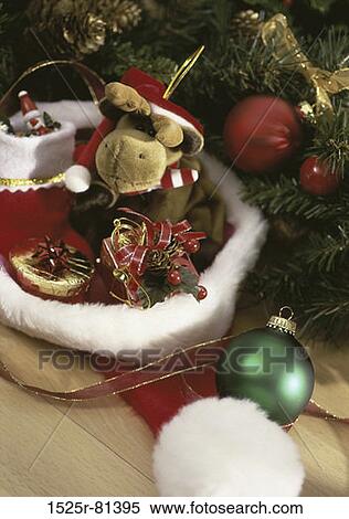 Christmas tree ornaments and gifts in a Santa hat View Large Photo Image Stock Photography - Christmas tree ornaments and gifts in a Santa hat. Fotosearch