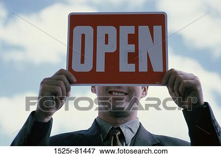 Close-up of a businessman holding an open sign View Large Photo Image Stock Photo - Close-up of a businessman holding an open sign. Fotosearch