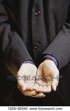 Close-up of a businessman holding out his hands View Large Photo Image Picture - Close-up of a businessman holding out his hands. Fotosearch