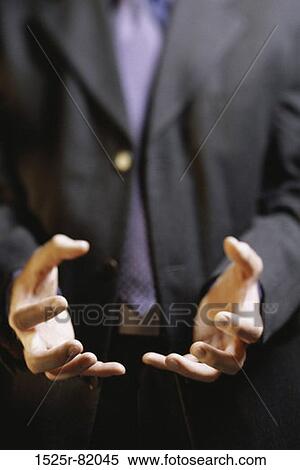 Stock Photography - Close-up of a businessman holding out his hands. Fotosearch