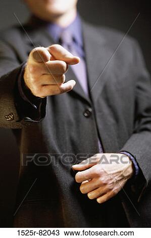 Close-up of a businessman pointing forward View Large Photo Image Stock Image - Close-up of a businessman pointing forward. Fotosearch