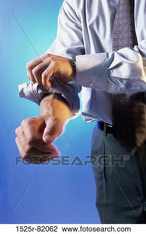 Close-up of a businessman rolling up his sleeves View Large Photo Image Stock Image - Close-up of a businessman rolling up his sleeves. Fotosearch