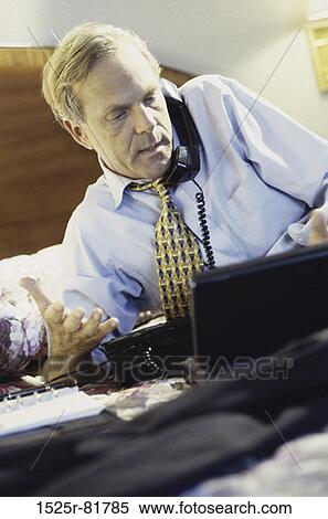 Close-up of a businessman talking on a telephone View Large Photo Image Stock Photography - Close-up of a businessman talking on a telephone. Fotosearch