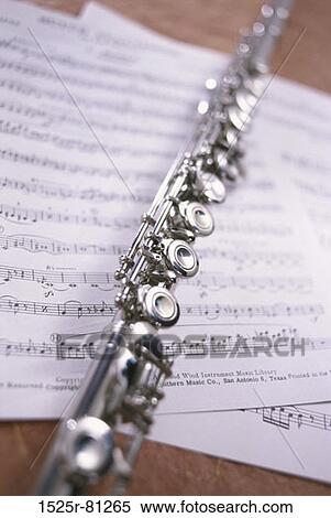 Close-up of a flute on music sheets View Large Photo Image Stock Photography - Close-up of a flute on music sheets. Fotosearch