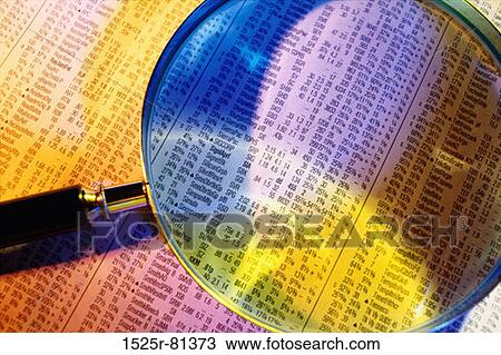 Stock Image - Close-up of a magnifying glass on a financial report. Fotosearch