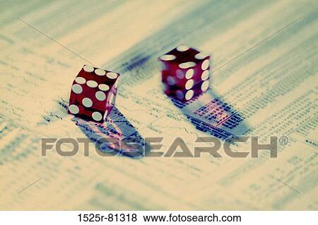 Stock Photo - Close-up of a pair of dice on a stock market paper. Fotosearch