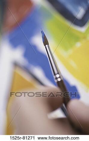 Close-up of a person holding a paintbrush View Large Photo Image Stock Image - Close-up of a person holding a paintbrush. Fotosearch