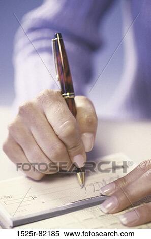 Stock Photography - Close-up of a person writing a check. Fotosearch