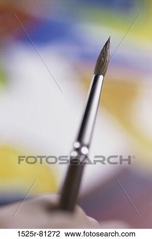 Close-up of a person's hand holding a paintbrush View Large Photo Image Stock Image - Close-up of a person's hand holding a paintbrush. Fotosearch