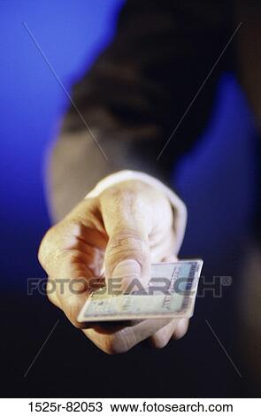 Close-up of a person's hand holding a credit card View Large Photo Image Stock Image - Close-up of a person's hand holding a credit card. Fotosearch